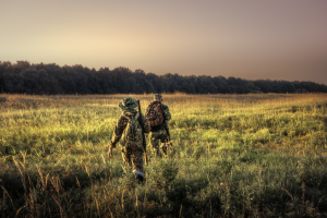 Photo of two hunters walking in a field